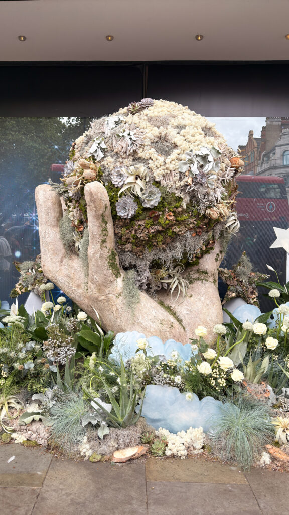 Floral earth in hand installation at Chelsea in Bloom 2026 demonstrating experiential retail storytelling
