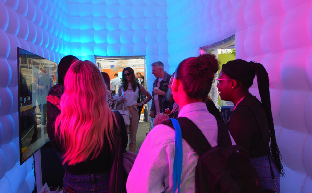 Visitors inside NORTHBANKS’ immersive inflatable installation at VM & Display Show 2026, featuring experiential lighting and interactive retail design elements.