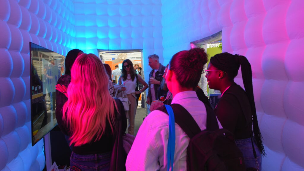 Visitors inside NORTHBANKS’ immersive inflatable installation at VM & Display Show 2026, featuring experiential lighting and interactive retail design elements.
