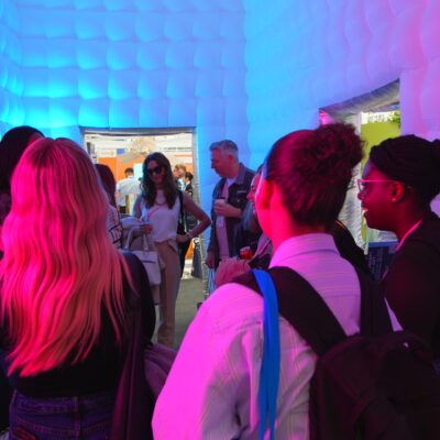 Visitors inside NORTHBANKS’ immersive inflatable installation at VM & Display Show 2026, featuring experiential lighting and interactive retail design elements.