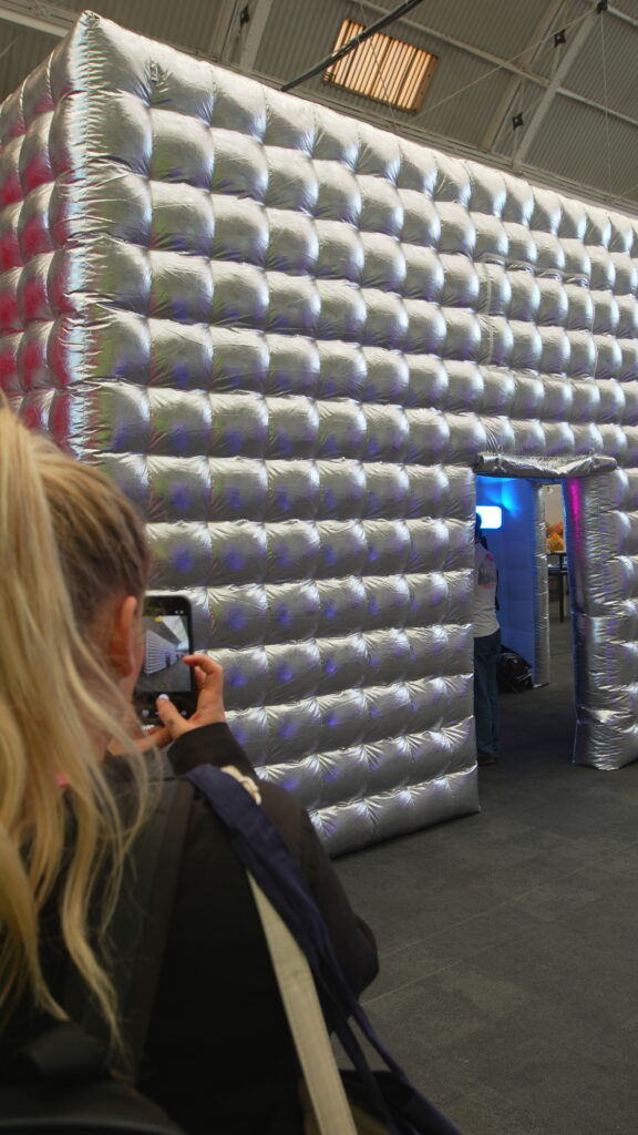 Attendee photographing a large inflatable experiential retail installation at VM & Display Show 2026.
