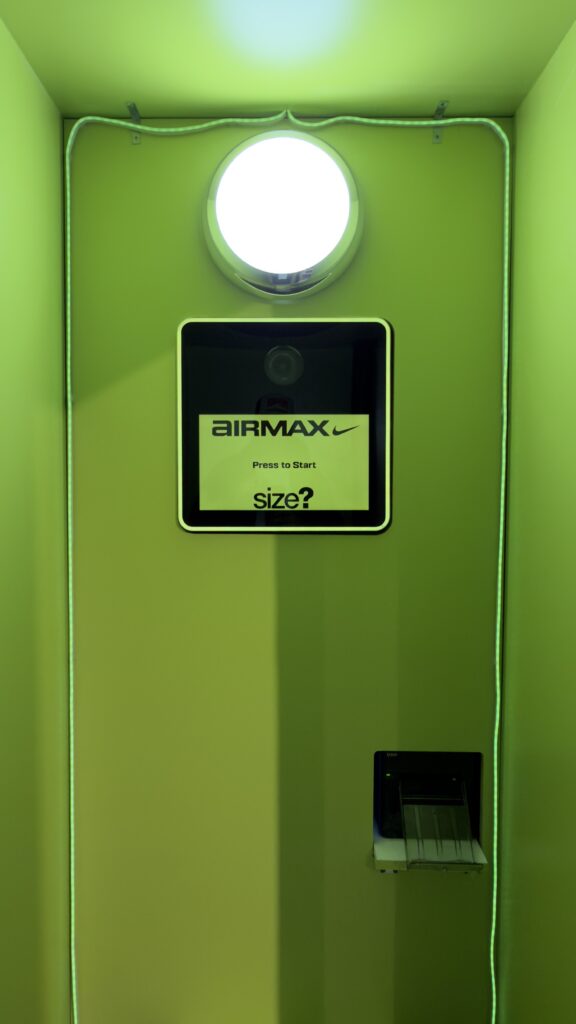 Photobooth at Exhibition-style Nike product presentation inside experiential retail installation
