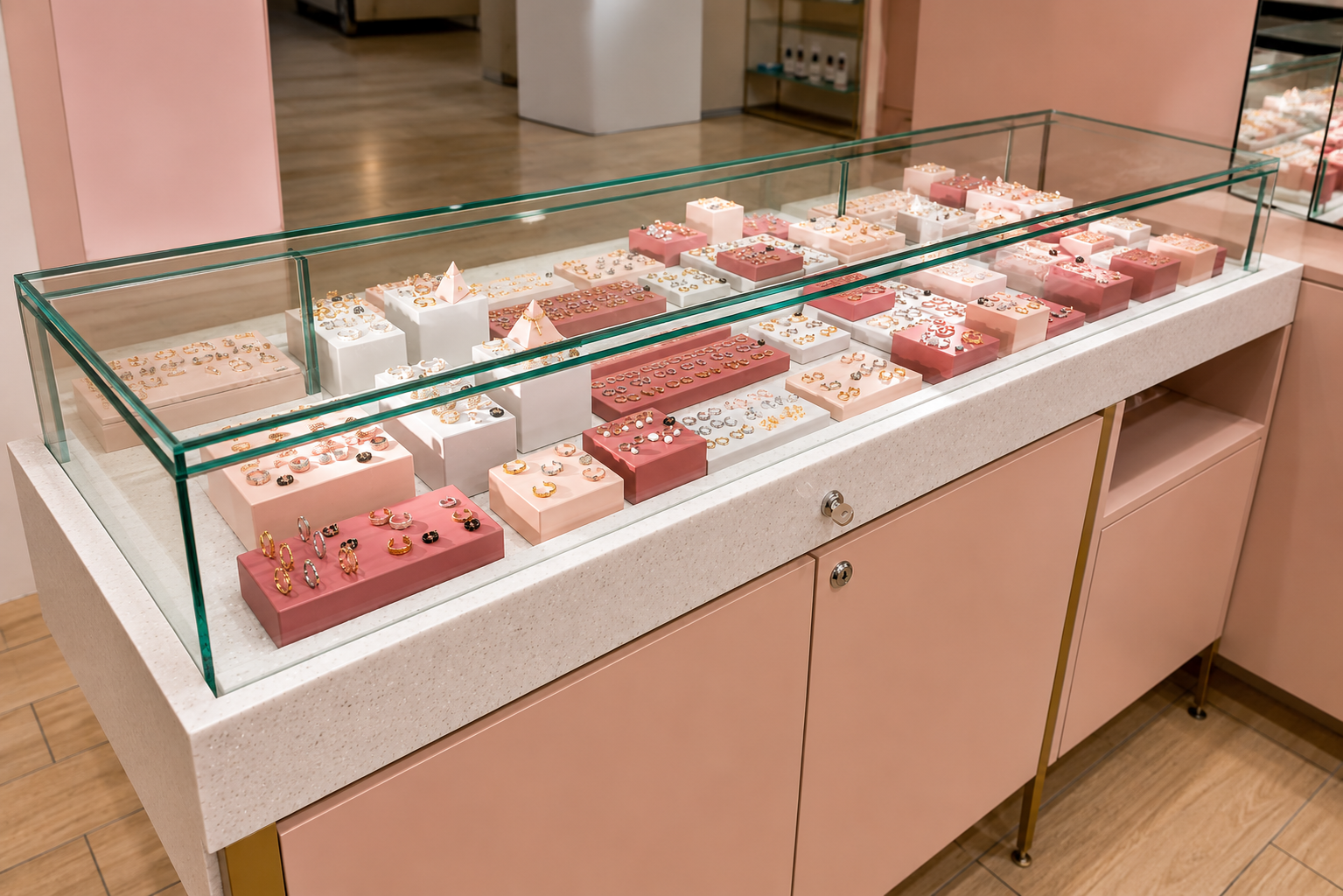 Close-up of jewellery merchandising display within the Astrid & Miyu concession featuring bespoke glass showcases and branded display plinths.